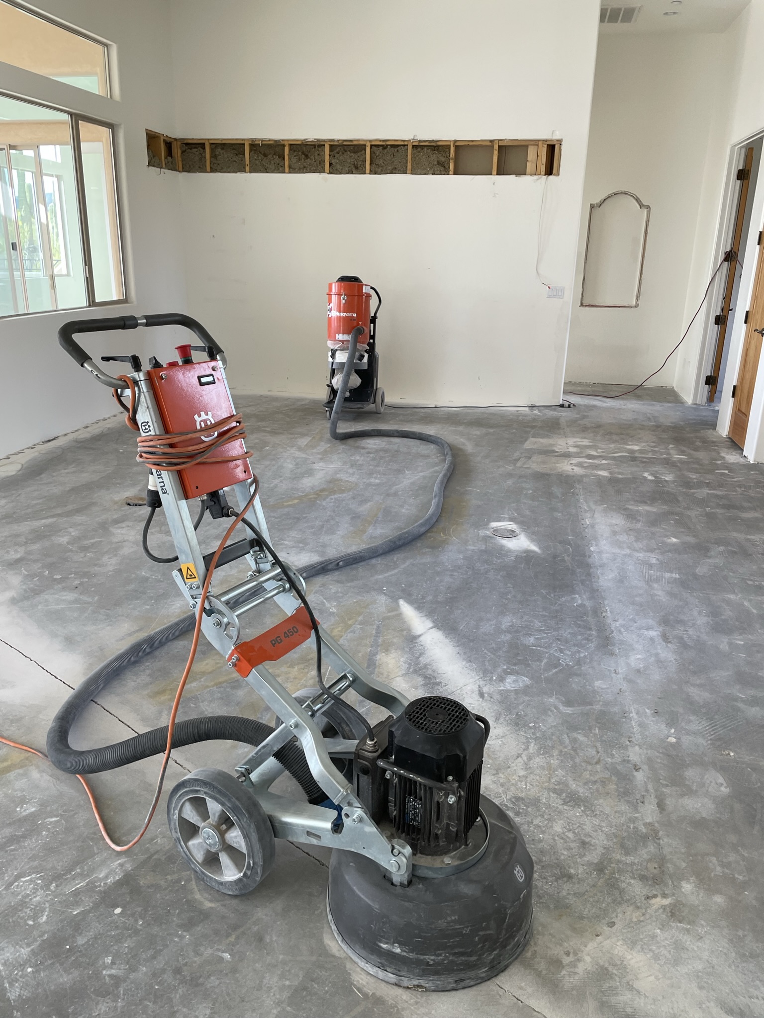 Husqvarna grinder and vacuum finishing up removed tile.