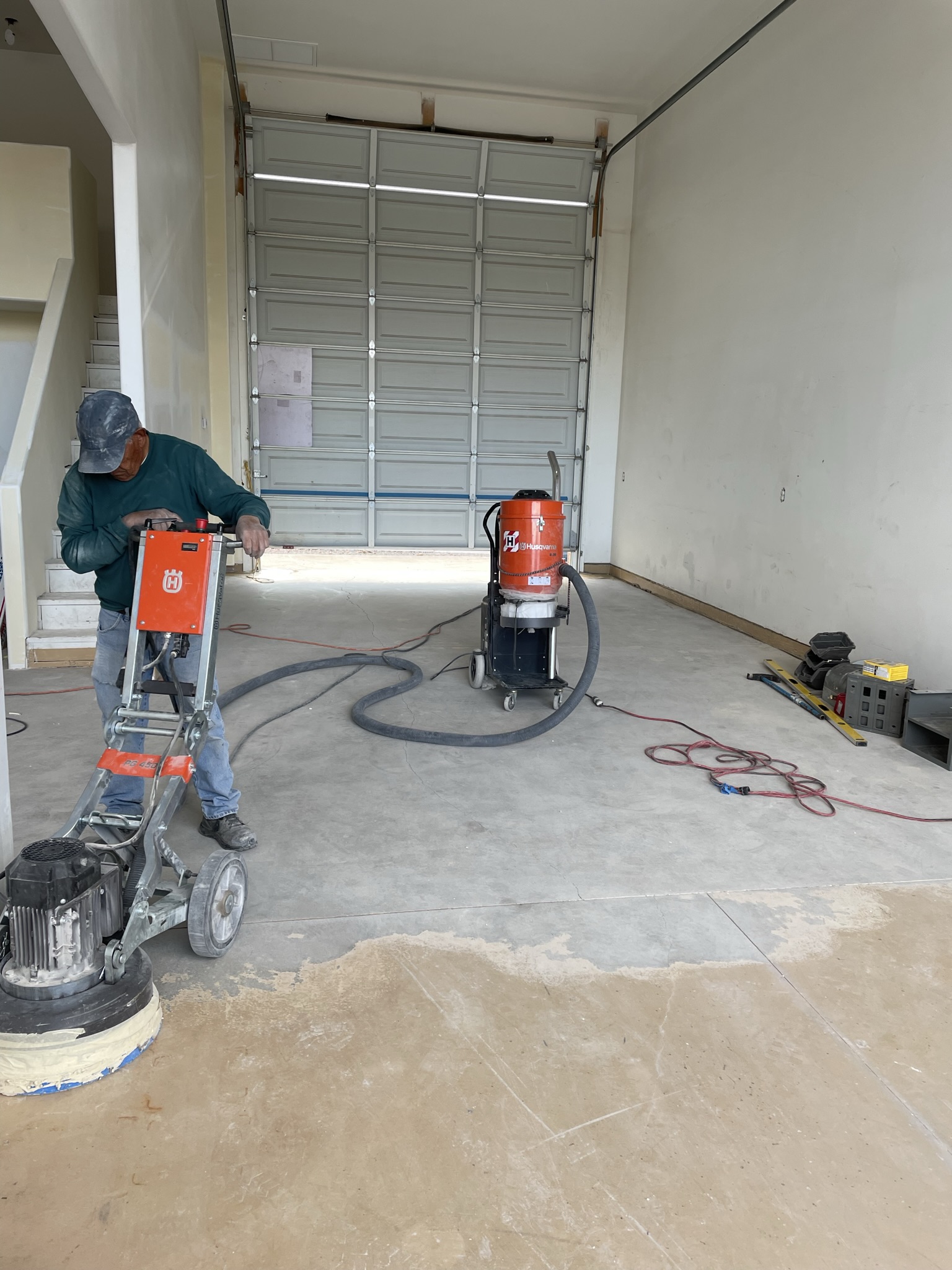 Grinding old paint from RV garage, prepping for epoxy.